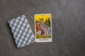 Esoteric tarot cards for fortune telling on a gray stone background